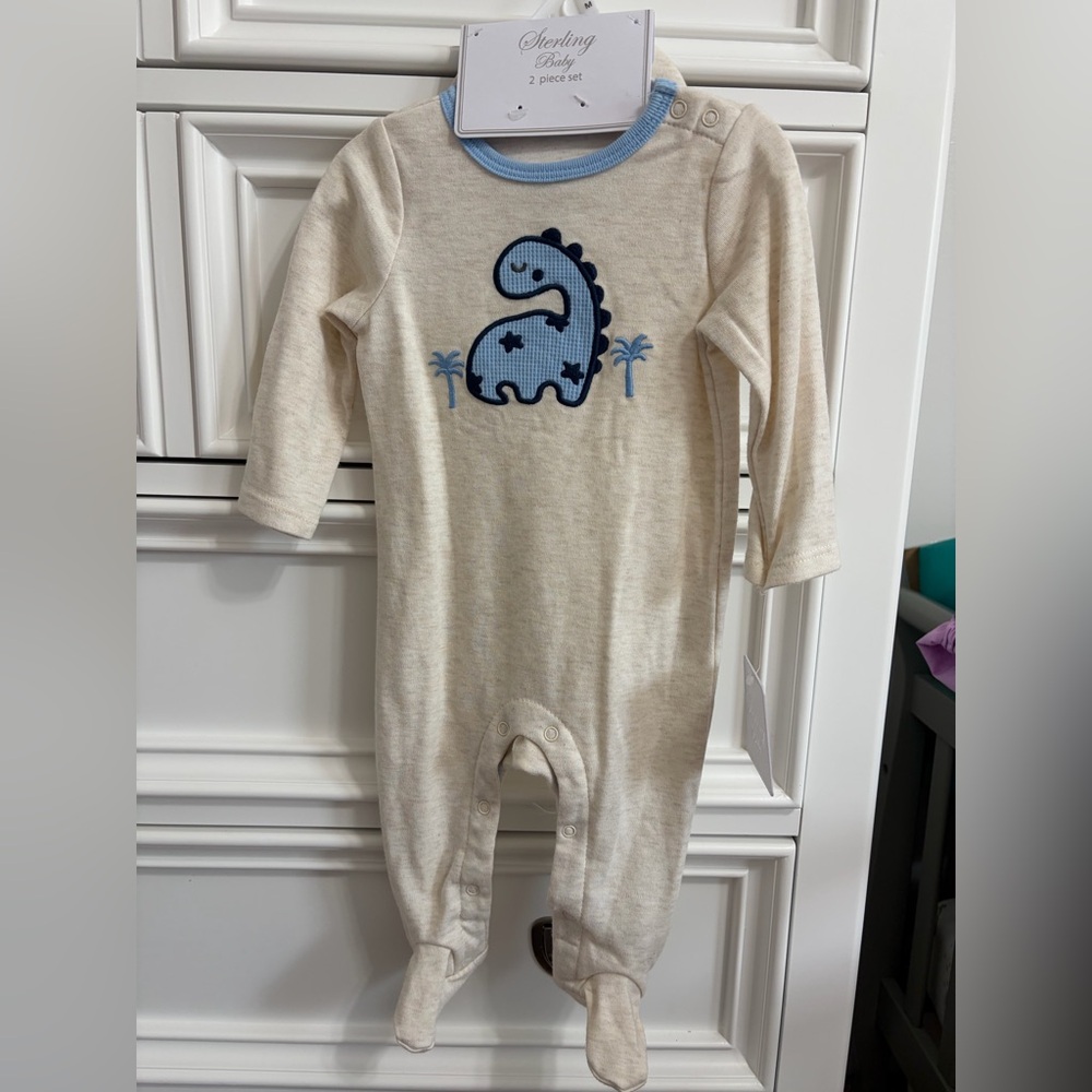 Sterling Baby Cream Footie Pajamas with cute Blue Dino Hat included.